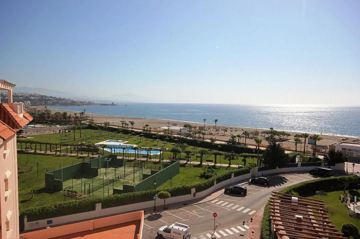 Beachfront south-east facing 3-bed apartment with pool and gardens in central Sabinillas.