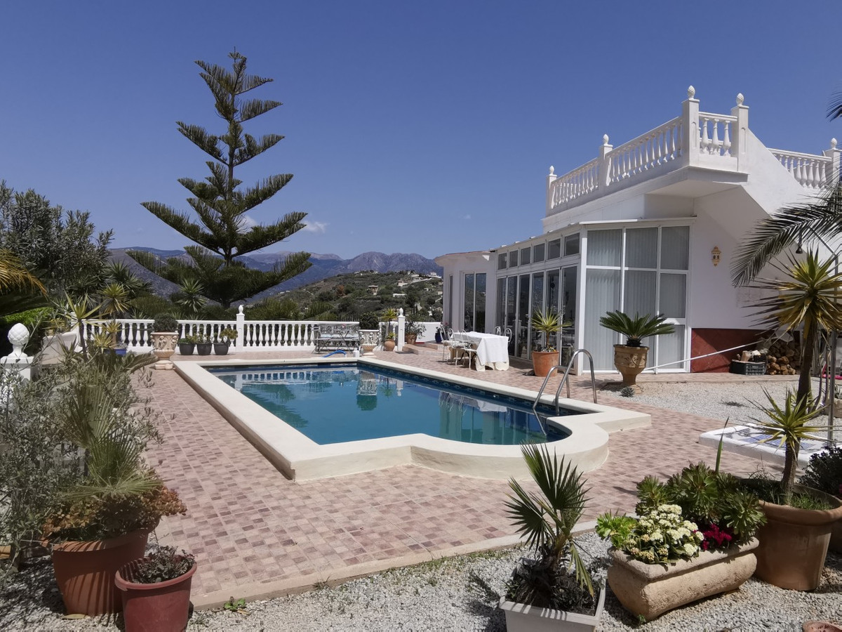 Beautiful Villa with spectacular sea and mountain views in Torrox, consisting of a main house with two living rooms, one with fireplace and one for...