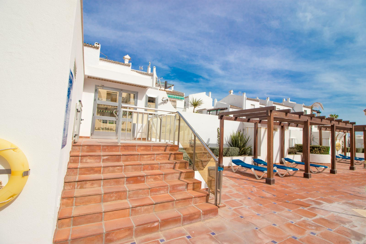 Beautiful beachfront 2-bed 2-bath ground floor apartment with private terrace.