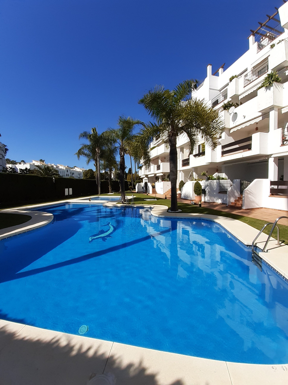 "Bright beachside corner apartment located in one of the most prestigious and established residential developments of Puerto Banus.With a wonderful...