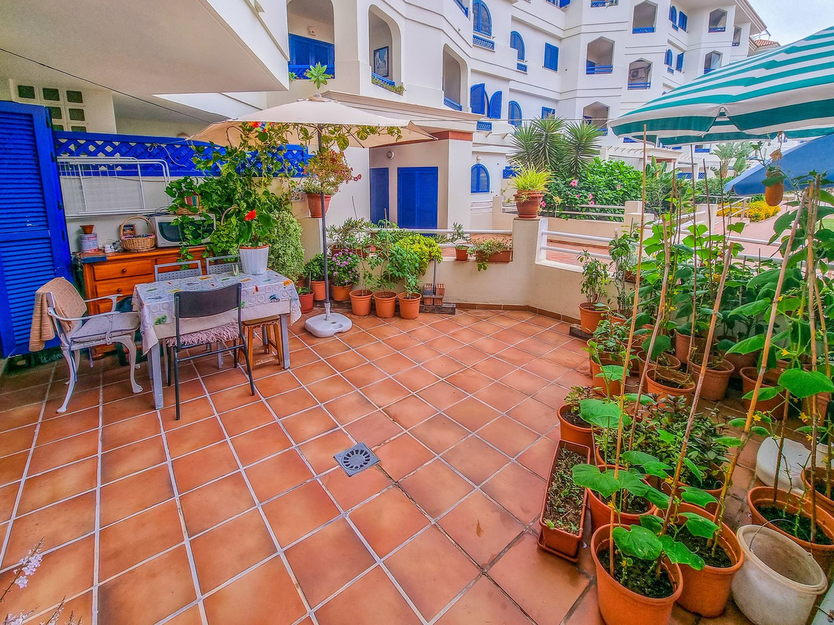 Beachfront 2-bedroom ground floor apartment with large private terrace in Sabinillas.