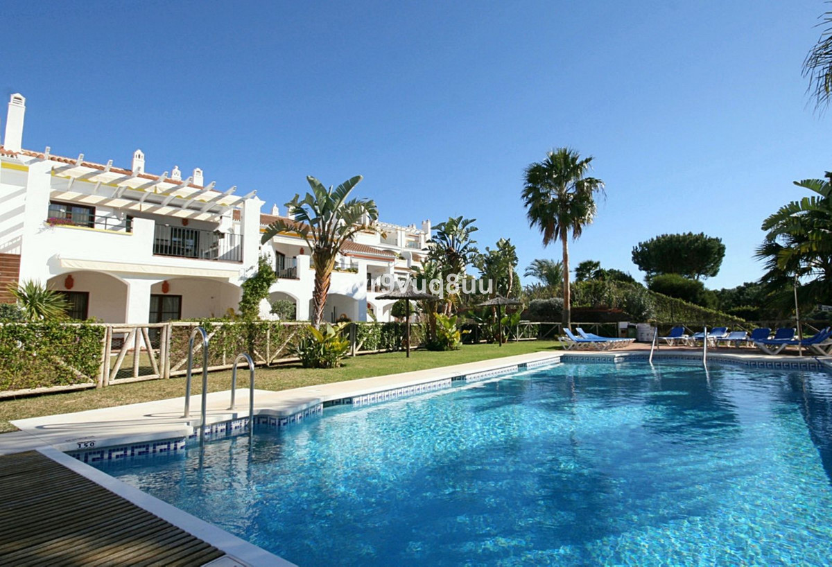 This really impressive end terrace town house is situated in one of the most exclusive communities i, Spain