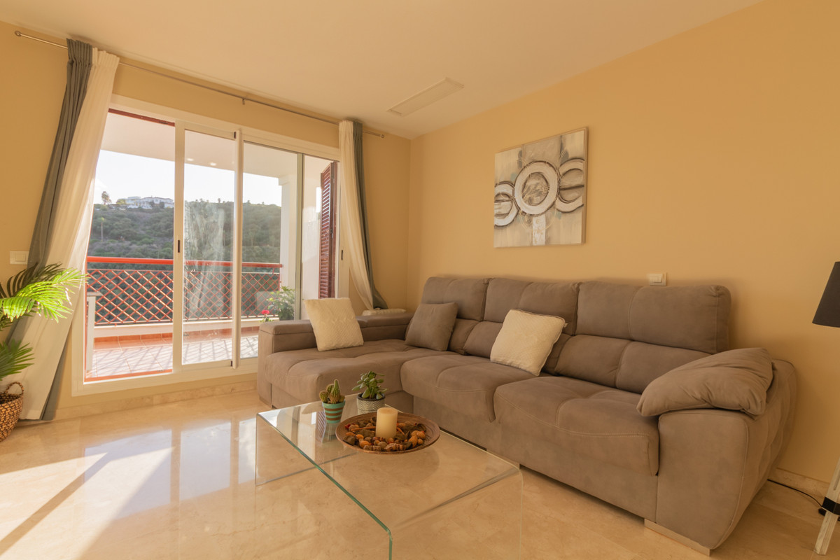 Spacious south facing flat in perfect condition in Residencial Nueva Alcaidesa with mountain, lake and sea views.