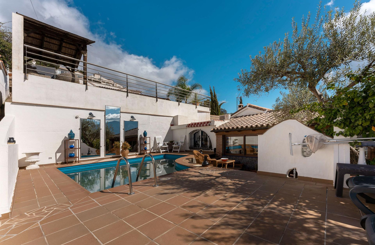 Charming Andalusian style detached villa with a lovely enclosed ‘L&apos; shaped terrace with large French patio doors, situated on a small and quaint